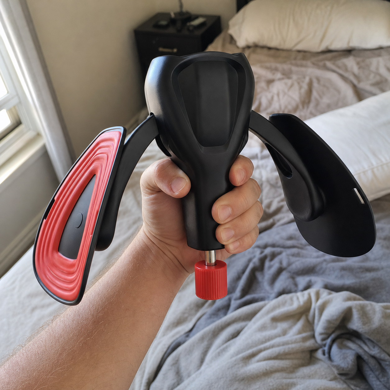 Body-Forge men's resistance trainer held in a home setting